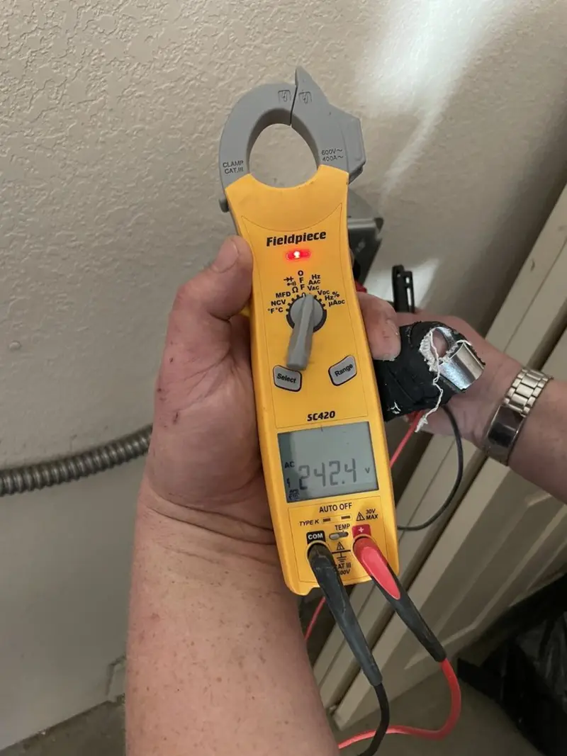 Voltage testing with clamp meter during Whole House Surge Protector in The Homesteads
